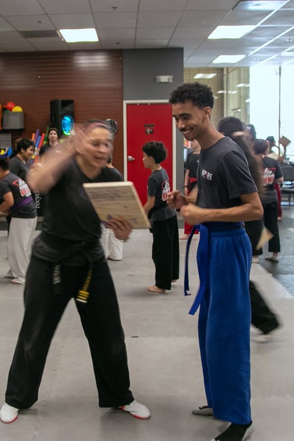 An Inspire instructor celebrating a participant’s achievement