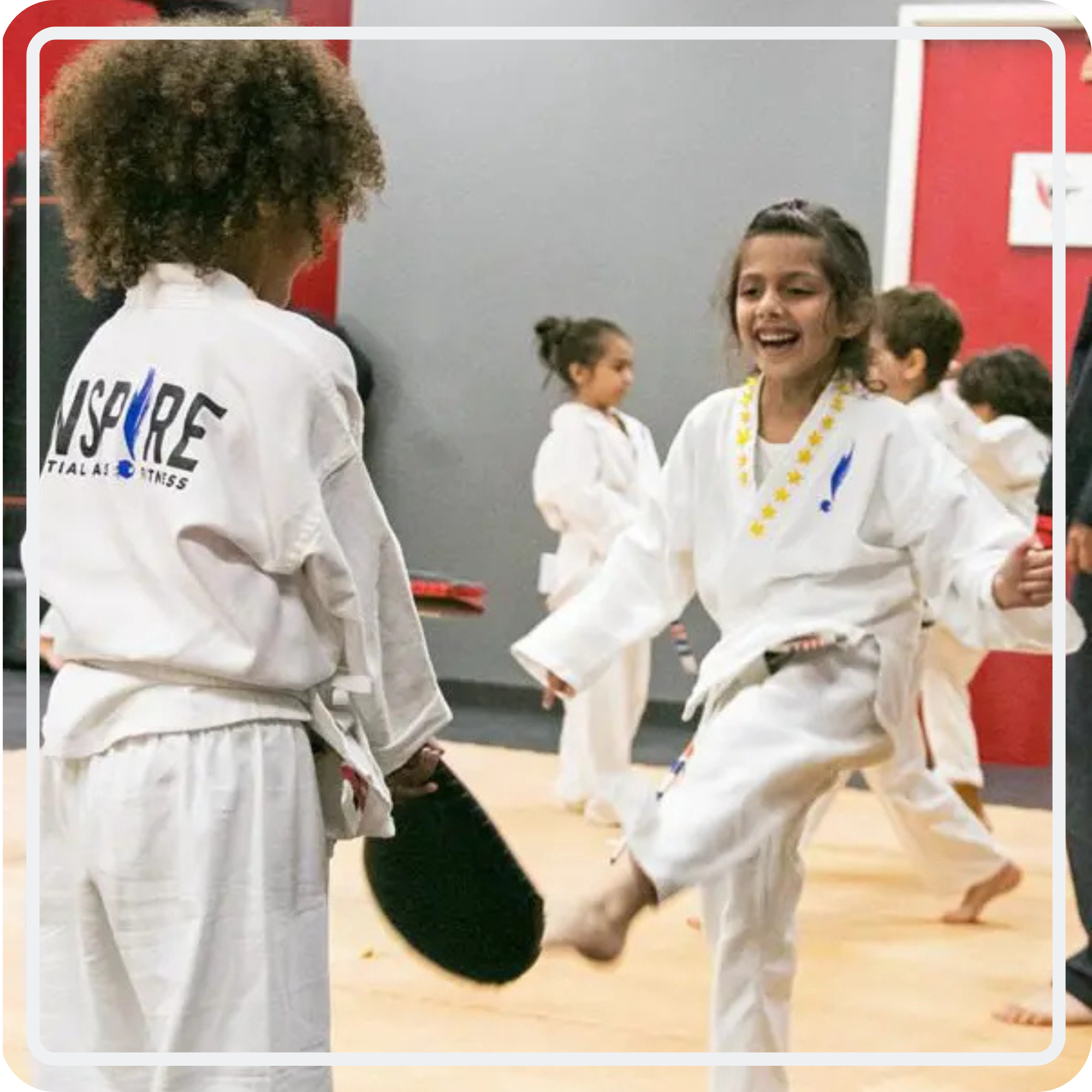 Inspired Kids students practicing martial arts partner drills